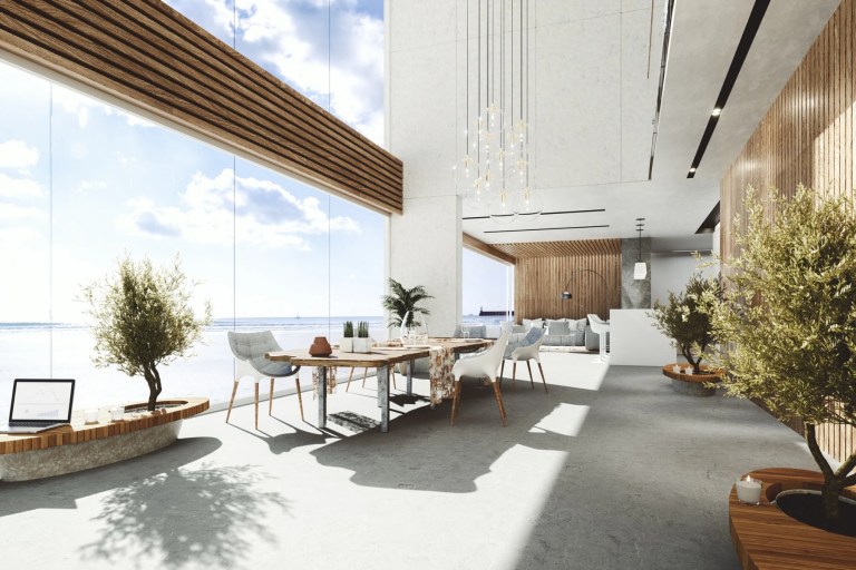 Modern open-plan condo interior with floor-to-ceiling windows onto a beach